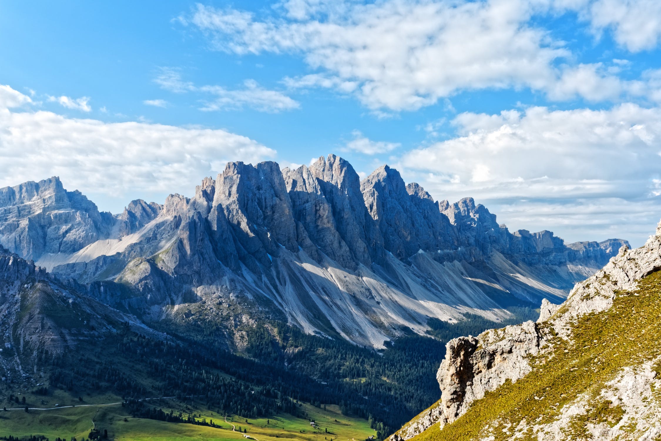 Rocky towers above a green alpine valley